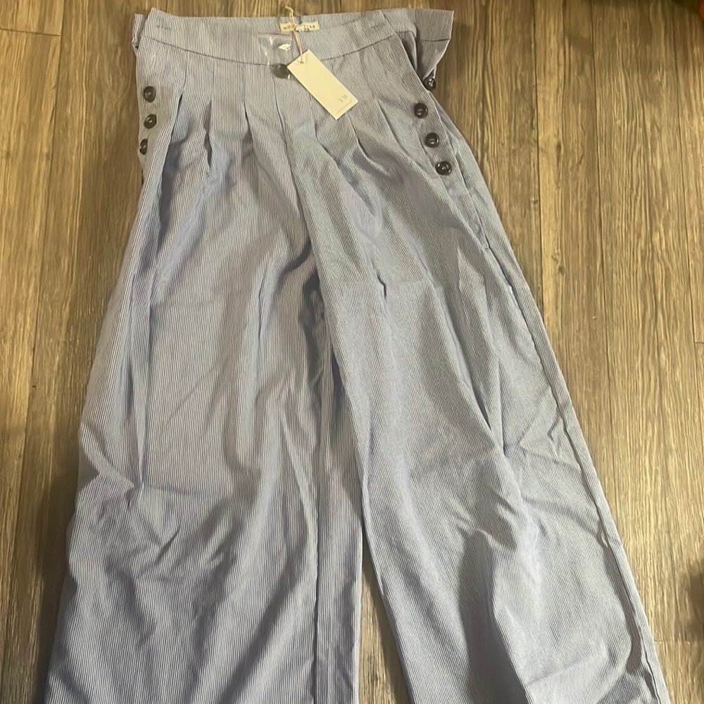 Blue and white pin stripe wide leg pants with button accent on side